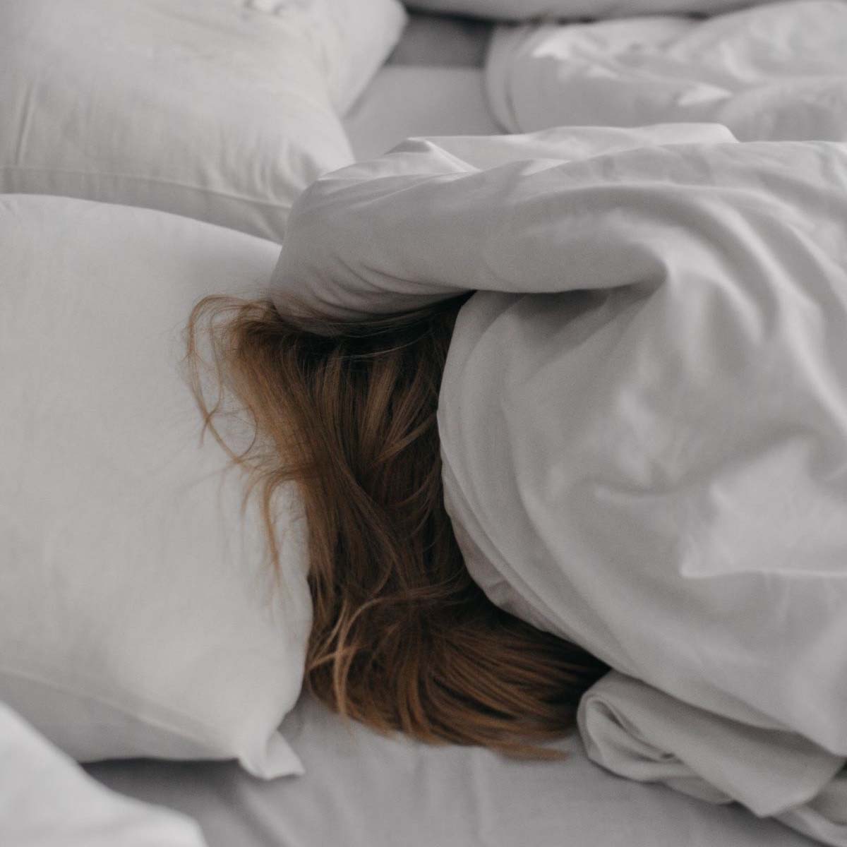 Woman with doona cover over head