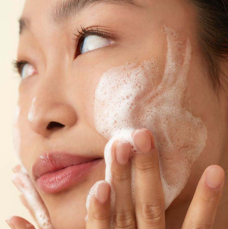 Woman Using Fresco Collections Absolute Balance Gel Cleanser